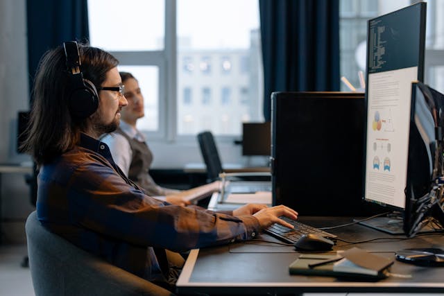 Zwei Männer, die in einem Büro arbeiten, konzentriert und kooperativ in einer produktiven Arbeitsumgebung.